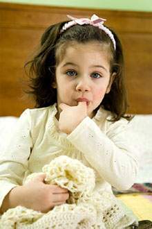 stock photo of little girl sucking thumb